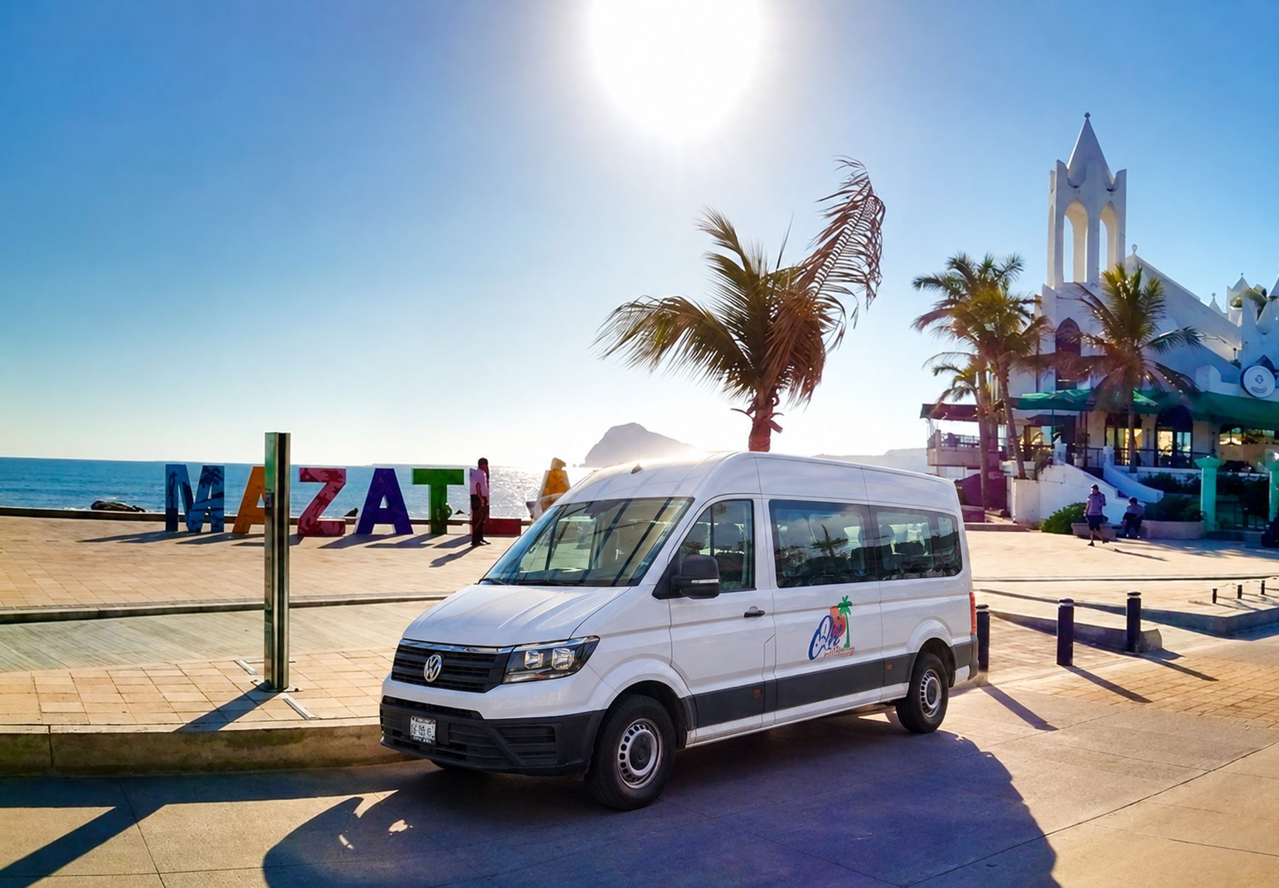 Olé Tours van parked by the MAZATLÁN letters on the malecón at sunset